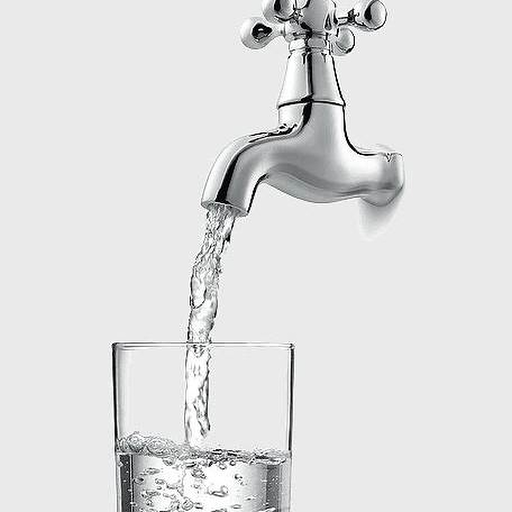 Fresh water pouring from a faucet into a glass